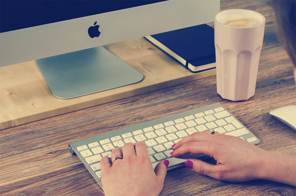 Person typing on a keyboard