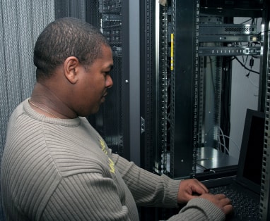 man working in server room image